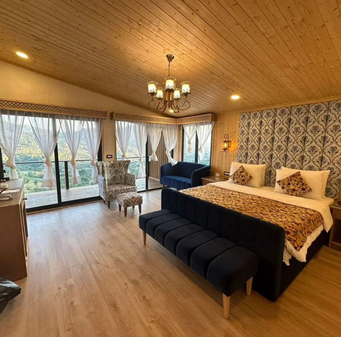 Warm, wood-lined bedroom with natural light and a green view